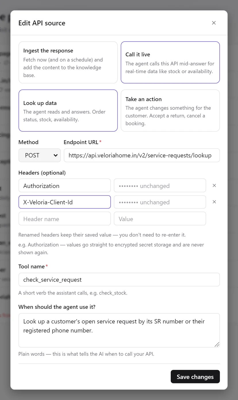 The Edit API source dialog showing two saved headers with masked values marked unchanged, one of them renamed, and the hint that renamed headers keep their saved value
